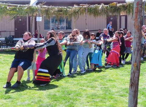 Girls of all ages work hard to win a tug-of-war contest against the boys. Ramadas, built by Noli Indian School students, encircled the courtyard to provide shade for visitors Girls of all ages work hard to win a tug-of-war contest against the boys. Ramadas, built by Noli Indian School students, encircled the courtyard to provide shade for visitors