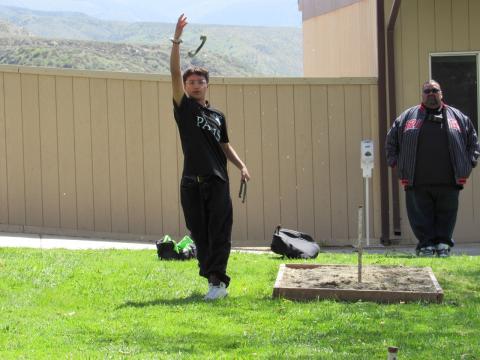 Jonathan Gladin (Oglala Sioux) pitches a horseshoe during a competition held at the 18th annual Gathering of the People at Noli Indian School Jonathan Gladin (Oglala Sioux) pitches a horseshoe during a competition held at the 18th annual Gathering of the People at Noli Indian School