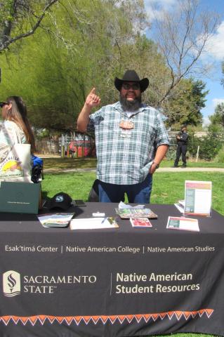 Joaquin Tarango, representing Sacramento State’s Native American College, gives a “sting” sign, to signify the college’s mascot, the hornet Joaquin Tarango, representing Sacramento State’s Native American College, gives a “sting” sign, to signify the college’s mascot, the hornet