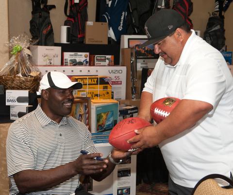 NFL star, Christian “The Nigerian Nightmare” Okoye, gives autographed footballs to Soboba Tribal Vice Chairman and Soboba Foundation board member Isaiah Vivanco to be auctioned off at the fifth annual charity golf tournament on April 7 NFL star, Christian “The Nigerian Nightmare” Okoye, gives autographed footballs to Soboba Tribal Vice Chairman and Soboba Foundation board member Isaiah Vivanco to be auctioned off at the fifth annual charity golf tournament on April 7