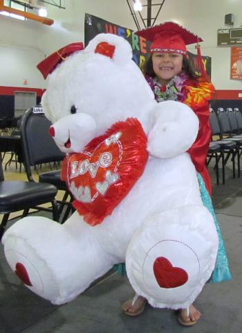 Kindergartner Victoria “Vicky” Boiso, 6, receives a pre-graduation gift of a giant stuffed bear before the ceremony on June 2. “I can’t believe we’re graduating,” she said Kindergartner Victoria “Vicky” Boiso, 6, receives a pre-graduation gift of a giant stuffed bear before the ceremony on June 2. “I can’t believe we’re graduating,” she said