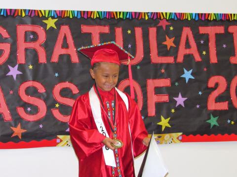 Kindergartner Kihuut-Tuukut Adame shows his parents the medal he was awarded for his perfect attendance Kindergartner Kihuut-Tuukut Adame shows his parents the medal he was awarded for his perfect attendance