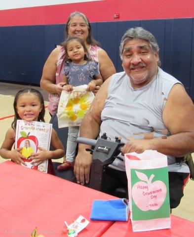 Tara and Patrick Placencia enjoy spending the morning with two of their 10 grandchildren that attend the Soboba Tribal Preschool. Holding the handmade gifts they made are Talla Grant, left, who is in kindergarten, and Layla Placencia, who is in the preschool class Tara and Patrick Placencia enjoy spending the morning with two of their 10 grandchildren that attend the Soboba Tribal Preschool. Holding the handmade gifts they made are Talla Grant, left, who is in kindergarten, and Layla Placencia, who is in the preschool class