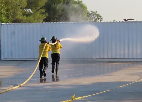 Kuamai Banks and Jeremiah Ramos use teamwork to guide the fire hose toward its target during a recent Soboba Fire Explorer program drill Kuamai Banks and Jeremiah Ramos use teamwork to guide the fire hose toward its target during a recent Soboba Fire Explorer program drill