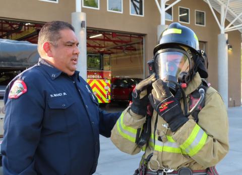 Fire Training Captain Howard Maxcy Jr. checks the apparatus donned by Explorer Abigail Arres during a recent meeting of the Soboba Fire Explorers Fire Training Captain Howard Maxcy Jr. checks the apparatus donned by Explorer Abigail Arres during a recent meeting of the Soboba Fire Explorers