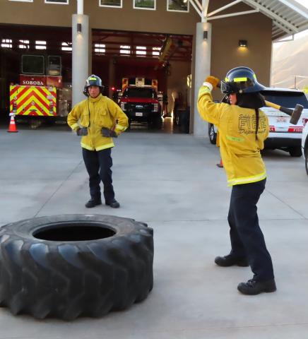 Jeremiah Ramos wields a sledgehammer to simulate when firefighters have to use heavy axes to break through roofs during structure fires to allow inside fumes and flames to escape. Fellow Explorer Kuamai waits his turn for the drill Jeremiah Ramos wields a sledgehammer to simulate when firefighters have to use heavy axes to break through roofs during structure fires to allow inside fumes and flames to escape. Fellow Explorer Kuamai waits his turn for the drill