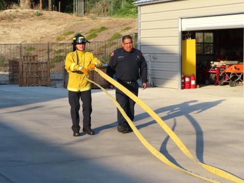 Jeremiah Ramos works on quickly straightening out a rolled fire hose under the direction of Fire Training Captain Howard Maxcy Jr. during a recent Soboba Fire Explorer program drill Jeremiah Ramos works on quickly straightening out a rolled fire hose under the direction of Fire Training Captain Howard Maxcy Jr. during a recent Soboba Fire Explorer program drill