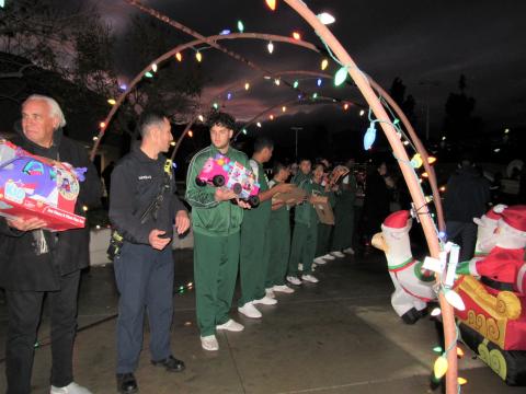 At Tahquitz High School on Dec. 9, volunteers make sure all 1,000 toys designated for HUSD families are transported from the bus to the campus’ storage area At Tahquitz High School on Dec. 9, volunteers make sure all 1,000 toys designated for HUSD families are transported from the bus to the campus’ storage area