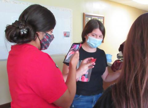 Soboba Youth Council Chairwoman Iyana Briones, left, videotapes the Soboba Youth Council Back-to-School Scavenger Hunt raffle drawing via Instagram on Aug. 28 while Tatiana “Roo” Briones holds the cup of raffle tickets Soboba Youth Council Chairwoman Iyana Briones, left, videotapes the Soboba Youth Council Back-to-School Scavenger Hunt raffle drawing via Instagram on Aug. 28 while Tatiana “Roo” Briones holds the cup of raffle tickets