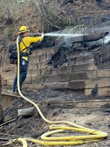 A Soboba Fire crew member mops up hotspots ensuring the fire is completely extinguished A Soboba Fire crew member mops up hotspots ensuring the fire is completely extinguished