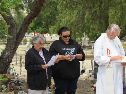A roll call of veterans was read by Marian Chacon and Kelli Hurtado as Father Earl Henley follows along during a Memorial Day recognition program at Soboba Cemetery on May 27 A roll call of veterans was read by Marian Chacon and Kelli Hurtado as Father Earl Henley follows along during a Memorial Day recognition program at Soboba Cemetery on May 27
