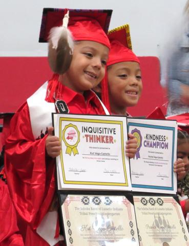 Twins Kut and Paa’kal Vega-Castello proudly show their diplomas and certificates to family members taking their photos Twins Kut and Paa’kal Vega-Castello proudly show their diplomas and certificates to family members taking their photos