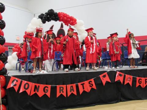 Kindergartners entertain the audience with a Bruno Mars song prior to receiving their diplomas and certificates Kindergartners entertain the audience with a Bruno Mars song prior to receiving their diplomas and certificates