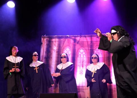 Jim Lineberger, at right, leads the group for Valley Community Pantry’s “Most Original” performance of “I Will Follow Him” from the movie Sister Act Jim Lineberger, at right, leads the group for Valley Community Pantry’s “Most Original” performance of “I Will Follow Him” from the movie Sister Act