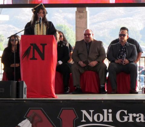 Noli Indian School valedictorian Violet Chacon speaks at the Class of 2018 commencement on June 6 while Noli Principal Donovan Post and counselor Clyde Miller, at right, and others listen Noli Indian School valedictorian Violet Chacon speaks at the Class of 2018 commencement on June 6 while Noli Principal Donovan Post and counselor Clyde Miller, at right, and others listen
