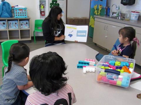 Maritza Zaragoza reads her story about feeding the hungry to children at Soboba Tribal Preschool Maritza Zaragoza reads her story about feeding the hungry to children at Soboba Tribal Preschool