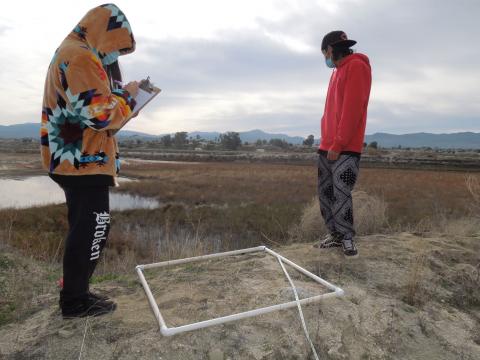 Noli Indian School science students Sienna Goff and Victor Chavez sample plant species in a watershed area at the Soboba Indian Reservation