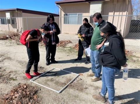 Noli teacher Jay Dagostino and Cultural Resource Specialist Jessica Valdez work with science students on reading a quadrant for plant species in a sampling technique on land adjacent to the school’s campus as part of the habitat restoration project Noli teacher Jay Dagostino and Cultural Resource Specialist Jessica Valdez work with science students on reading a quadrant for plant species in a sampling technique on land adjacent to the school’s campus as part of the habitat restoration project
