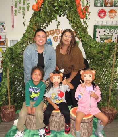 Pre-K aide Alaina Adkins, left and Pre-K teacher Ana Garcia with students Kavikvish Medina, Paa’at Mariscal and Nolani Miranda in the classroom’s jungle-themed reading hut Pre-K aide Alaina Adkins, left and Pre-K teacher Ana Garcia with students Kavikvish Medina, Paa’at Mariscal and Nolani Miranda in the classroom’s jungle-themed reading hut