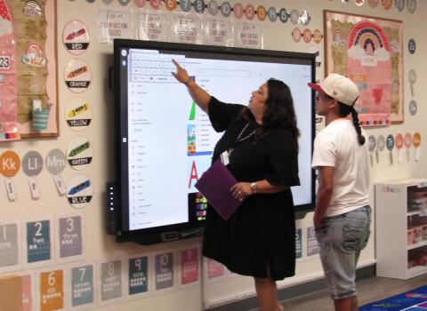Pre-kindergarten teacher Ana Garcia explains to a parent how computer technology is accessed on a daily basis within her classroom during a back-to-school night visit Pre-kindergarten teacher Ana Garcia explains to a parent how computer technology is accessed on a daily basis within her classroom during a back-to-school night visit