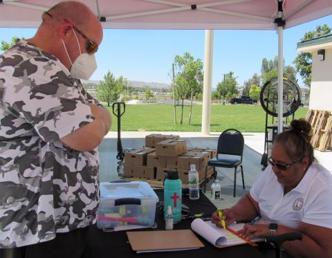 Noli Indian School Principal and Soboba Tribal Member Donovan Post, left, checks in with Soboba Foundation President Dondi Silvas to receive produce boxes for himself and family members during a recent weekly pickup at the Soboba Sports Complex Noli Indian School Principal and Soboba Tribal Member Donovan Post, left, checks in with Soboba Foundation President Dondi Silvas to receive produce boxes for himself and family members during a recent weekly pickup at the Soboba Sports Complex