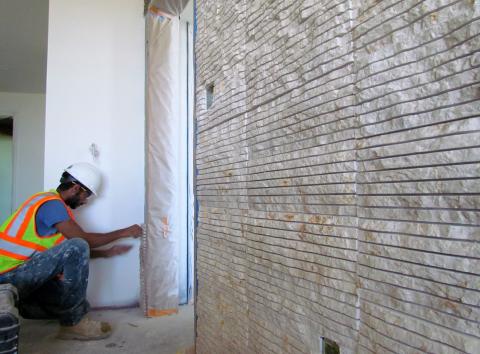 Mohamed "Karim" Mohamed was busy setting textured stone tiles to hotel room walls at the new Soboba resort project Mohamed "Karim" Mohamed was busy setting textured stone tiles to hotel room walls at the new Soboba resort project