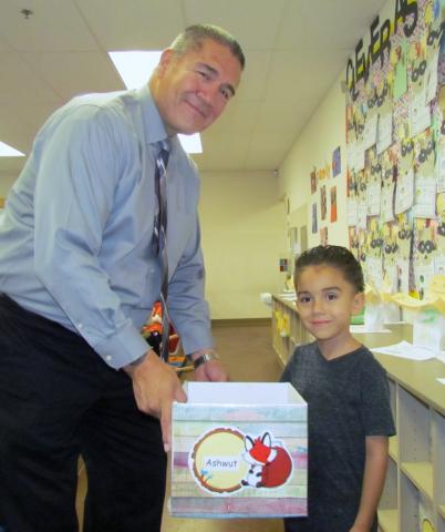 Kindergartner Ashwut Castello shares classwork items with his grandfather, Michael Castello, during Soboba Tribal Preschool’s Back-to-School Night on Sept. 12 Kindergartner Ashwut Castello shares classwork items with his grandfather, Michael Castello, during Soboba Tribal Preschool’s Back-to-School Night on Sept. 12