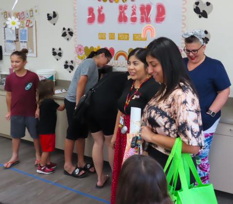 Soboba Tribal Preschool kindergarten teacher Sierra Vivanco, center, chats with Victoria Bentiste about her son Joseph Jr. while classroom aide Amber Young, back right, interacts with other parents during this year’s Back-to-School night, Aug. 24