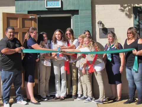 Soboba’s Isaiah Vivanco, left, and Dondi Silvas, far right, hold the ribbon for cutting by Girl Scout Troop 2412 during the ceremony to mark the completion of Project Sparkle at the Hemet Scout House on Oct. 19.