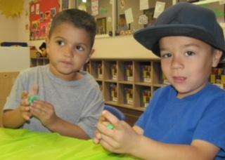 Pre-K students Brian Ortiz and Logan Lopez enjoy making shapes with the green slime they created with their teacher, Amanda Vallin Pre-K students Brian Ortiz and Logan Lopez enjoy making shapes with the green slime they created with their teacher, Amanda Vallin