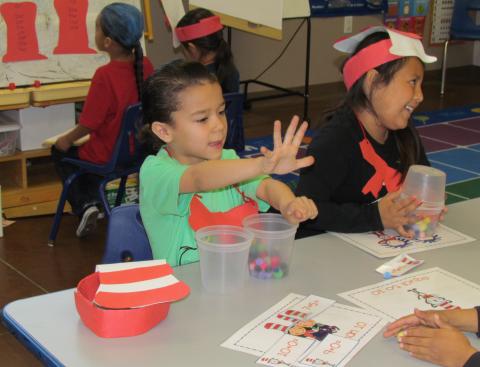Kindergartners Logan Lopez, left and Marlee Mendoza enjoy some math games with a Dr. Seuss theme on March 1 Kindergartners Logan Lopez, left and Marlee Mendoza enjoy some math games with a Dr. Seuss theme on March 1