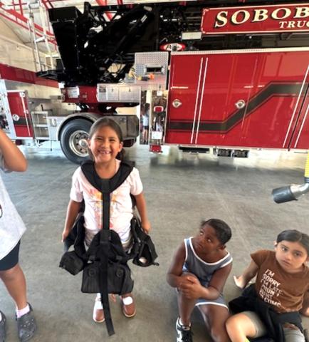 Clover Swan, 6, dons firefighter gear during the Summer Program’s field trip to the Soboba Fire Station, June 24, as Charlie Mae Hunter looks on Clover Swan, 6, dons firefighter gear during the Summer Program’s field trip to the Soboba Fire Station, June 24, as Charlie Mae Hunter looks on
