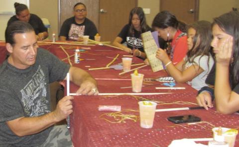 Tony Soares shows some arrow-making techniques to Tanya Rivera during a recent workshop at Soboba Tribal TANF’s Summer Youth Academy
