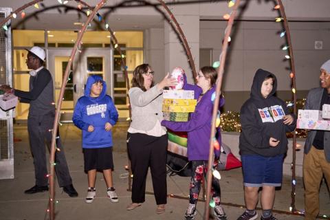 Toys are eagerly passed along the line of helpers that extends from the bus in the parking lot to the cafeteria storeroom at the Tahquitz High School campus Toys are eagerly passed along the line of helpers that extends from the bus in the parking lot to the cafeteria storeroom at the Tahquitz High School campus