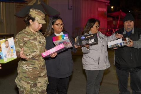 Volunteers check out the toys as they are passed along from the bus to the San Jacinto Unified School District warehouse. From left, San Jacinto High School Air Force JROTC cadet Jocelyn Rodriguez and fellow cadet Rhianna Salgado, Maria Vivanco and Mike Bentiste, from Soboba Volunteers check out the toys as they are passed along from the bus to the San Jacinto Unified School District warehouse. From left, San Jacinto High School Air Force JROTC cadet Jocelyn Rodriguez and fellow cadet Rhianna Salgado, Maria Vivanco and Mike Bentiste, from Soboba
