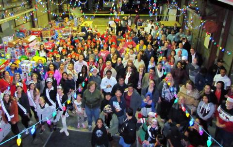 Many of the approximately 200 volunteers who helped “Unstuff the Bus” to support San Jacinto Unified School District gather in the festively decorated warehouse, now filled with toys donated to the district from the Soboba Gives Back Toy Drive Many of the approximately 200 volunteers who helped “Unstuff the Bus” to support San Jacinto Unified School District gather in the festively decorated warehouse, now filled with toys donated to the district from the Soboba Gives Back Toy Drive