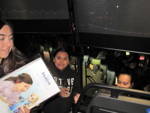 Several tribal youths helped unload toys from the bus to waiting community members, seen through the bus’ windshield, who passed them along in a human chain fashion for storage in San Jacinto Unified School District’s warehouse until its holiday distribution event on Dec. 14 Several tribal youths helped unload toys from the bus to waiting community members, seen through the bus’ windshield, who passed them along in a human chain fashion for storage in San Jacinto Unified School District’s warehouse until its holiday distribution event on Dec. 14