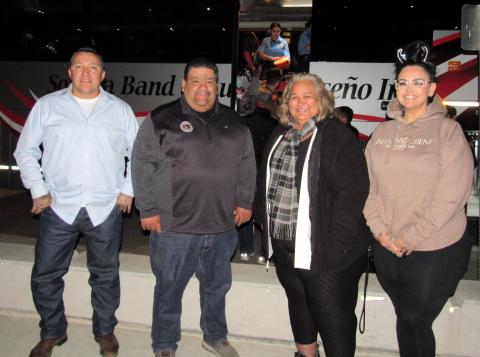 From left, Soboba Tribal Council Treasurer Daniel Valdez, Chairman Isaiah Vivanco, Soboba Foundation President Dondi Silvas and Vice President Catherine “Cat” Modesto. Behind them, members of the Hemet Police Department Explorers and other volunteers unstuff a busload of toys