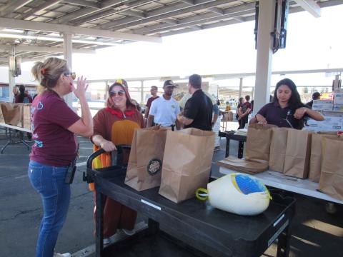 SJUSD’s Director of Nutrition Services Tammy White, left, chats with turkey costumed Michelle Woodfin from SCR during the Soboba Gives Back! turkey meal distribution event at San Jacinto High School SJUSD’s Director of Nutrition Services Tammy White, left, chats with turkey costumed Michelle Woodfin from SCR during the Soboba Gives Back! turkey meal distribution event at San Jacinto High School