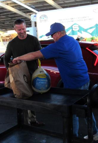 SJUSD Superintendent David Pyle, left, and Hemet-San Jacinto Chamber of Commerce board member Adam Eventov from SoCalGas, prepare to deliver a turkey meal to the trunk of a waiting vehicle during the Soboba Gives Back! annual Thanksgiving event SJUSD Superintendent David Pyle, left, and Hemet-San Jacinto Chamber of Commerce board member Adam Eventov from SoCalGas, prepare to deliver a turkey meal to the trunk of a waiting vehicle during the Soboba Gives Back! annual Thanksgiving event