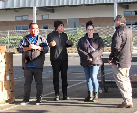 Volunteers await the next vehicle to arrive at the annual drive-through turkey distribution event at San Jacinto High School. From left, Joseph Placencia, Andrew Vallejos, Bernadette Jones, and Daniel Valdez Volunteers await the next vehicle to arrive at the annual drive-through turkey distribution event at San Jacinto High School. From left, Joseph Placencia, Andrew Vallejos, Bernadette Jones, and Daniel Valdez