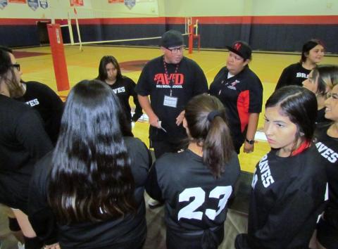 Coaches Brian Savage and Andrea Helms, center, gather the team for a quick pep talk before the start of their game on Sept. 25. Coaches Brian Savage and Andrea Helms, center, gather the team for a quick pep talk before the start of their game on Sept. 25.