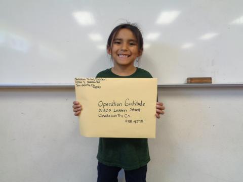 Kindergarten student Ete’tish Suun Arviso holds up the envelope where all the students letters were sent for Veteran’s Day Kindergarten student Ete’tish Suun Arviso holds up the envelope where all the students letters were sent for Veteran’s Day