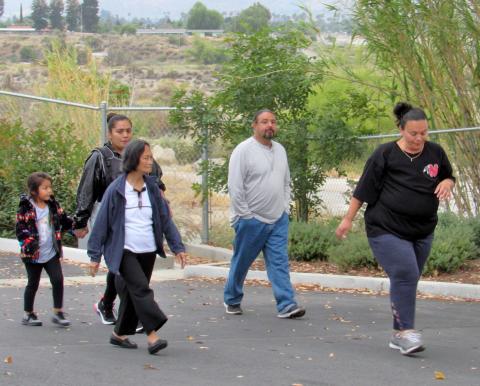 Kelli Hurtado, at right, leads a walking group during a recent Let’s Get Moving Mondays program session Kelli Hurtado, at right, leads a walking group during a recent Let’s Get Moving Mondays program session