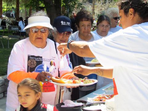 Carrie Garcia, at right, serves lunch to elders first after arriving at The Oaks on Saturday Carrie Garcia, at right, serves lunch to elders first after arriving at The Oaks on Saturday