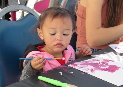 Talla Grant, 1, ponders her color choice during the Soboba Tribal TANF Paint Workshop at The Oaks Talla Grant, 1, ponders her color choice during the Soboba Tribal TANF Paint Workshop at The Oaks