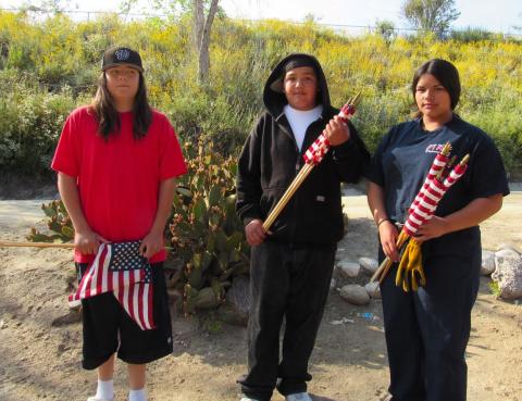 Soboba Tribal Youth Council members, from left, Ryan Brittian, 13, Nowaniiki Resvaloso, 13, and Raya Salgado, 14, help place flags for veterans at the Soboba Cemetery prior to the Memorial Day ceremony Soboba Tribal Youth Council members, from left, Ryan Brittian, 13, Nowaniiki Resvaloso, 13, and Raya Salgado, 14, help place flags for veterans at the Soboba Cemetery prior to the Memorial Day ceremony
